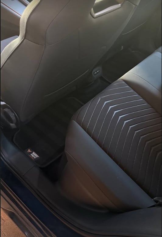 Interior view of car seats showing dark upholstery with pinstriped pattern