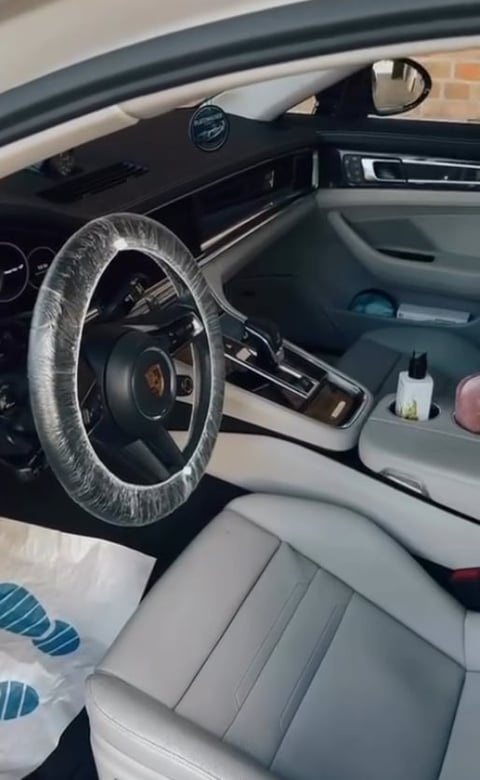 Interior of a car with steering wheel covered in plastic wrap