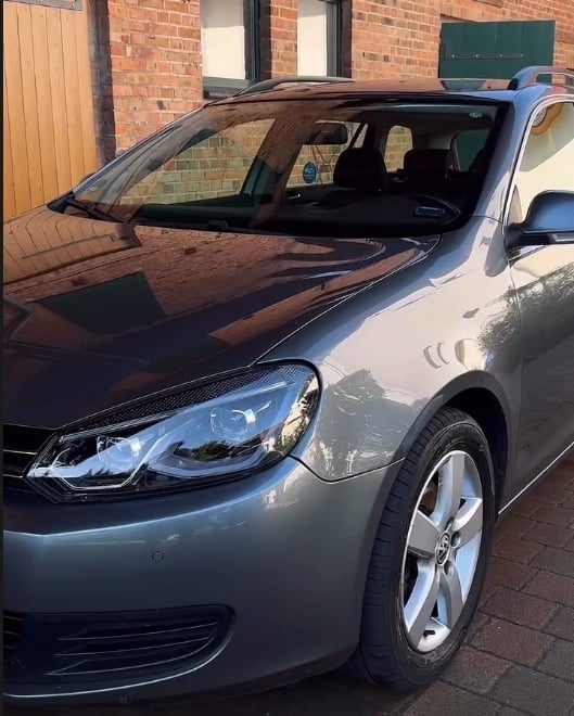 Silver hatchback car parked on brick driveway with open hood