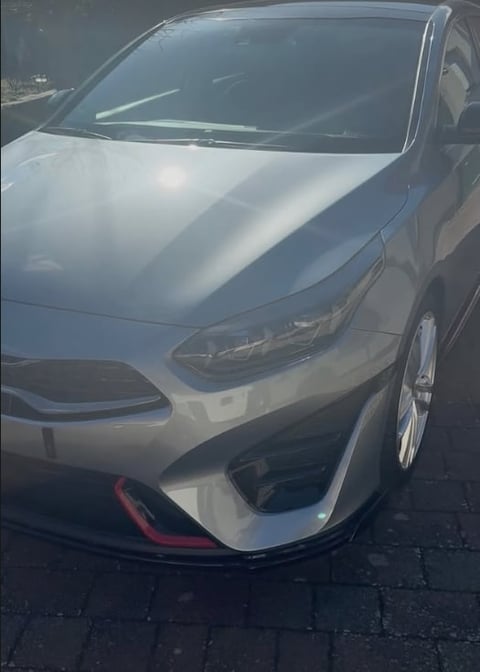 White sedan car photographed from above showing the hood and windshield